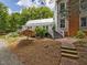 Exterior of the home showcasing a well-manicured yard, mature trees and manicured landscaping at 967 Bynum Rd, Pittsboro, NC 27312