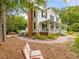 White two-story home featuring brick chimney and lush landscaping on a sunny day at 967 Bynum Rd, Pittsboro, NC 27312