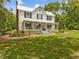 Beautiful two-story home with a metal roof, a large front porch, and a well-maintained lawn at 967 Bynum Rd, Pittsboro, NC 27312