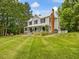 Lovely two-story home with a metal roof, a welcoming front porch, and a beautifully landscaped yard at 967 Bynum Rd, Pittsboro, NC 27312
