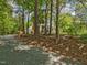 Exterior view of a beautiful two-story home with a charming front porch and mature trees at 967 Bynum Rd, Pittsboro, NC 27312