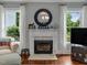 Relaxing living room with fireplace, white curtains, and windows with natural light at 967 Bynum Rd, Pittsboro, NC 27312