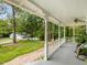 Scenic view from the covered front porch with lush green lawns and mature trees at 967 Bynum Rd, Pittsboro, NC 27312