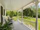Relaxing covered porch with rocking chairs and views of the expansive lawn at 967 Bynum Rd, Pittsboro, NC 27312