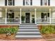 Inviting covered front porch with columns, steps, and manicured landscaping at 967 Bynum Rd, Pittsboro, NC 27312