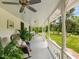 Spacious covered porch with ceiling fan and scenic views of the well-maintained yard at 967 Bynum Rd, Pittsboro, NC 27312