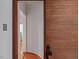 Hallway with wood paneled walls and access to other rooms at 967 Bynum Rd, Pittsboro, NC 27312