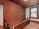 Wooden staircase and hallway with wood paneling and natural light at 967 Bynum Rd, Pittsboro, NC 27312