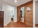 Wood-paneled hallway displaying a view of the interior with natural hardwood floors and trim at 967 Bynum Rd, Pittsboro, NC 27312