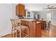 Kitchen with breakfast bar and view to the entry door at 967 Bynum Rd, Pittsboro, NC 27312