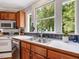 Kitchen with stainless steel sink and a view of the wooded landscape at 967 Bynum Rd, Pittsboro, NC 27312