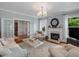 Bright living room with a fireplace, neutral furniture, and french doors at 967 Bynum Rd, Pittsboro, NC 27312