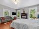 Spacious main bedroom with a fireplace, comfortable seating, and sun-filled windows at 967 Bynum Rd, Pittsboro, NC 27312