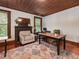Office space featuring wood floors, a fireplace, and natural light from the windows at 967 Bynum Rd, Pittsboro, NC 27312