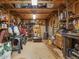 Interior view of outbuilding with wood beams, a stove, shelving, and tools at 967 Bynum Rd, Pittsboro, NC 27312