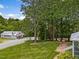 Landscaped yard with white fencing and mature trees creates a serene setting at 967 Bynum Rd, Pittsboro, NC 27312