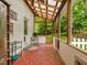 Relaxing screened porch features a wood ceiling and tile flooring, seamlessly connecting indoor and outdoor living at 967 Bynum Rd, Pittsboro, NC 27312