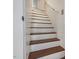 Stairway with white wood trim, hardwood stairs, and wood floors at 967 Bynum Rd, Pittsboro, NC 27312