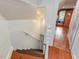 This view of a stairway shows hardwood floors, wooden stairs, and white walls at 967 Bynum Rd, Pittsboro, NC 27312