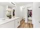 Spacious bathroom featuring a double vanity, a large mirror, wood-look flooring, and access to a walk-in closet at 1004 Gold Cir, Mebane, NC 27302