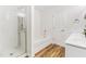 Modern bathroom featuring a walk-in shower, soaking tub and vanity with sink and wood-look floor at 1004 Gold Cir, Mebane, NC 27302