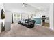 Inviting living room with neutral tones and a modern ceiling fan for added comfort at 1004 Gold Cir, Mebane, NC 27302