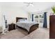 Bright main bedroom with vaulted ceiling, carpet, and a large window with blue curtains for ample natural light at 1004 Gold Cir, Mebane, NC 27302