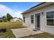 Back of house with a patio, spacious yard, and another structure in the background at 105 Seminole Fields Dr, Broadway, NC 27505