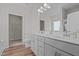 Bright bathroom featuring a double sink vanity, wood flooring, toilet, and access to the walk-in closet at 105 Seminole Fields Dr, Broadway, NC 27505