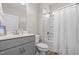 Well-lit bathroom with a shower-tub combo, modern vanity with a gray cabinet, and stylish fixtures at 105 Seminole Fields Dr, Broadway, NC 27505