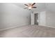 Spacious carpeted bedroom featuring a ceiling fan and doors to other rooms at 105 Seminole Fields Dr, Broadway, NC 27505