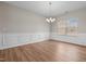 Elegant dining room with wood floors, wainscoting, chandelier, and natural light at 105 Seminole Fields Dr, Broadway, NC 27505