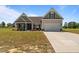 Charming home featuring a two-car garage, well-manicured lawn, and a welcoming entrance at 105 Seminole Fields Dr, Broadway, NC 27505