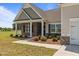Charming entrance with brick columns, manicured landscaping, and a cozy front porch at 105 Seminole Fields Dr, Broadway, NC 27505
