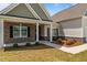 Inviting entryway with brick accents, lush landscaping, and a welcoming walkway at 105 Seminole Fields Dr, Broadway, NC 27505