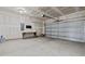 Spacious two-car garage featuring ample storage space, workbench, and a clean, functional layout at 105 Seminole Fields Dr, Broadway, NC 27505