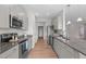 Spacious kitchen featuring gray cabinets, stainless steel appliances, and granite countertops at 105 Seminole Fields Dr, Broadway, NC 27505