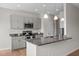 Charming kitchen features gray cabinets, granite countertops, and modern stainless steel appliances at 105 Seminole Fields Dr, Broadway, NC 27505