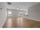 Inviting open-concept space with wood floors, ceiling fan, and kitchen view at 105 Seminole Fields Dr, Broadway, NC 27505
