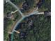 Aerial view of homes in a wooded community, offering privacy and tranquility at 106 N Duelling Oaks Dr, Chapel Hill, NC 27517