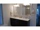 Bathroom with double vanity featuring marble countertops, mosaic backsplash, and framed mirrors at 106 N Duelling Oaks Dr, Chapel Hill, NC 27517
