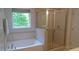 Relaxing bathroom features a soaking tub, separate glass-enclosed shower, and neutral tile surround at 106 N Duelling Oaks Dr, Chapel Hill, NC 27517