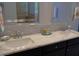 Bathroom with double vanity with framed mirrors and mosaic tile backsplash at 106 N Duelling Oaks Dr, Chapel Hill, NC 27517