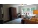 Cozy bedroom featuring natural light, comfortable seating, and ample closet space at 106 N Duelling Oaks Dr, Chapel Hill, NC 27517