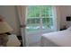 Bright bedroom featuring a large window with views of lush greenery at 106 N Duelling Oaks Dr, Chapel Hill, NC 27517
