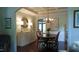 Elegant dining room with coffered ceiling, decorative chandelier, and classic furnishings at 106 N Duelling Oaks Dr, Chapel Hill, NC 27517