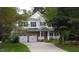 Charming two-story home featuring brick accents, a two-car garage, and a welcoming front porch at 106 N Duelling Oaks Dr, Chapel Hill, NC 27517