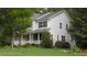 Beautiful home with a mix of siding and brick, a manicured lawn, and a charming front porch at 106 N Duelling Oaks Dr, Chapel Hill, NC 27517