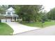 Suburban home with a well-manicured lawn and long driveway leading to the front entrance at 106 N Duelling Oaks Dr, Chapel Hill, NC 27517