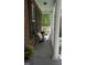Inviting front porch with chairs, decorative pillows, and plants, creating a cozy outdoor space at 106 N Duelling Oaks Dr, Chapel Hill, NC 27517